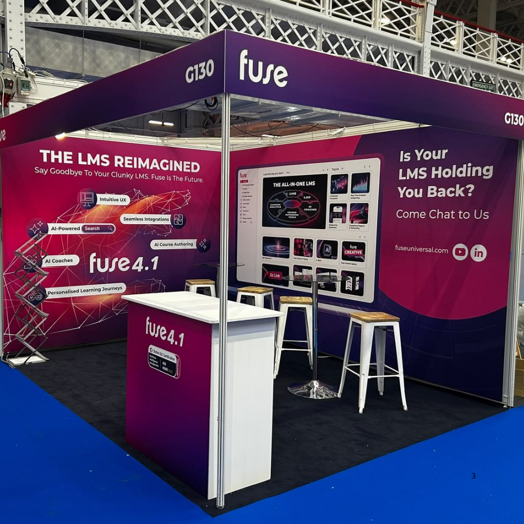 Fully branded 3x3 shell scheme booth with printed fabric graphics covering the back and side walls
