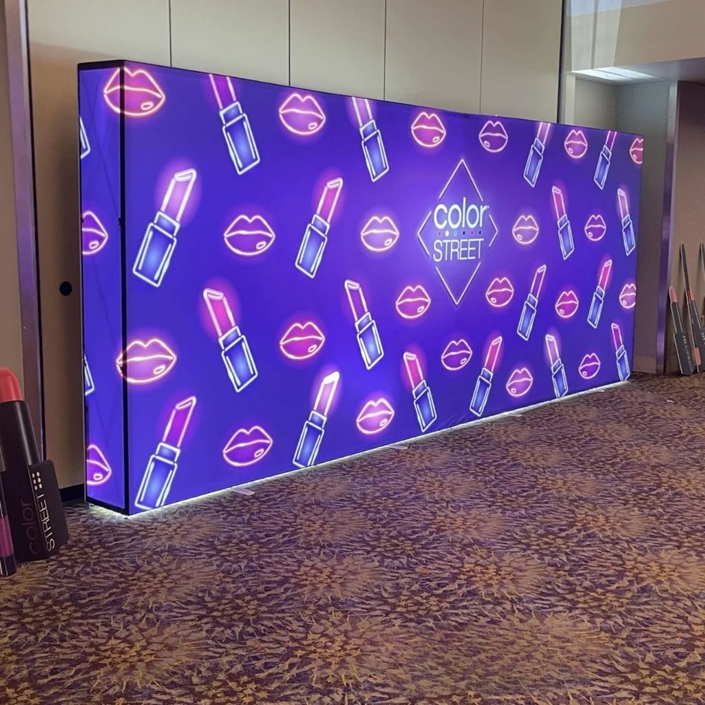 6m wide SEG backlit pop up media wall lit up in an event
