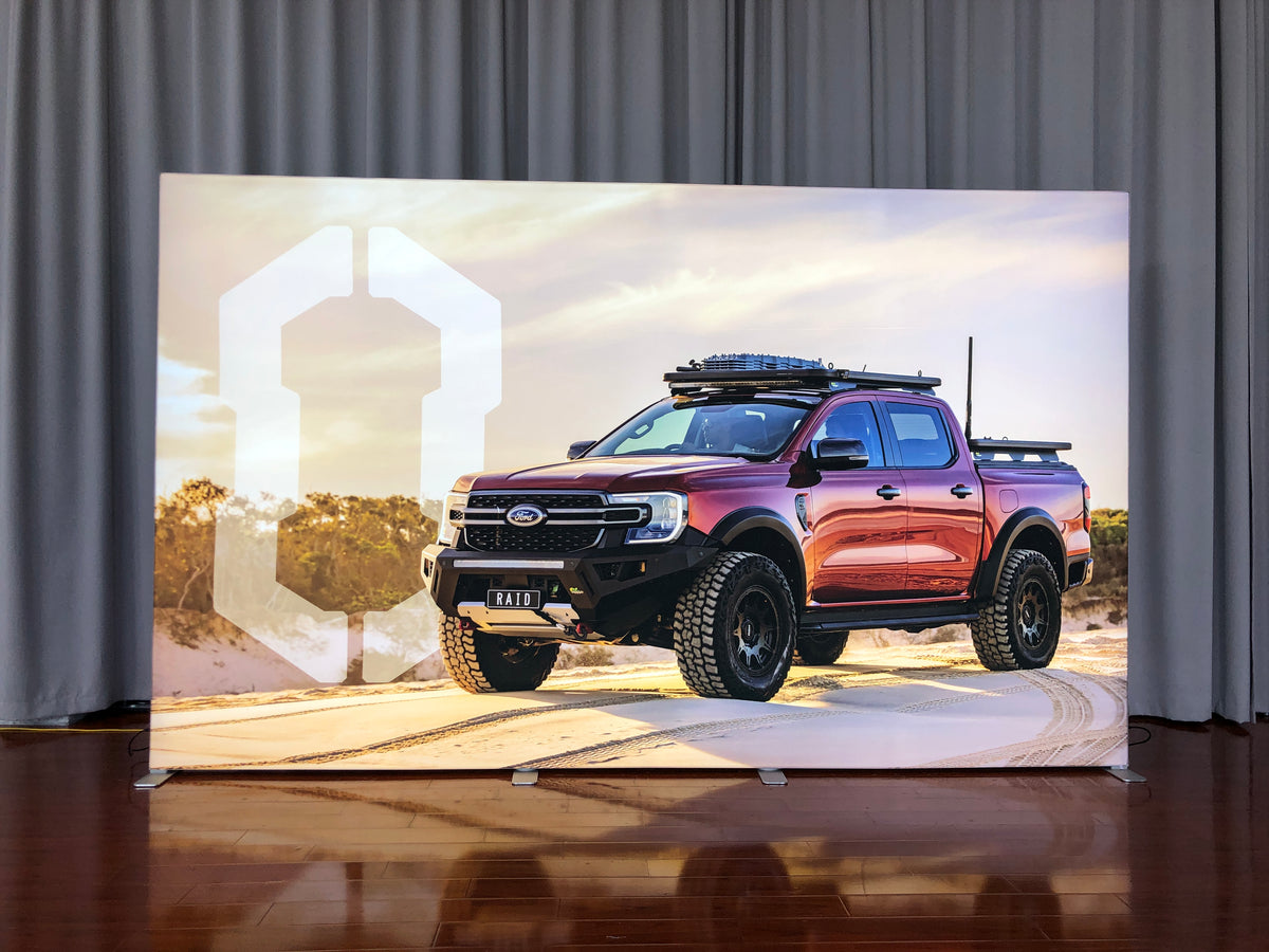 4m SEG backlit fabric media wall lit up on a premium tradeshow Stand
