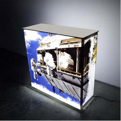 SEG backlit pop up counter 1m, custom printed and illuminated, at a trade show stand
