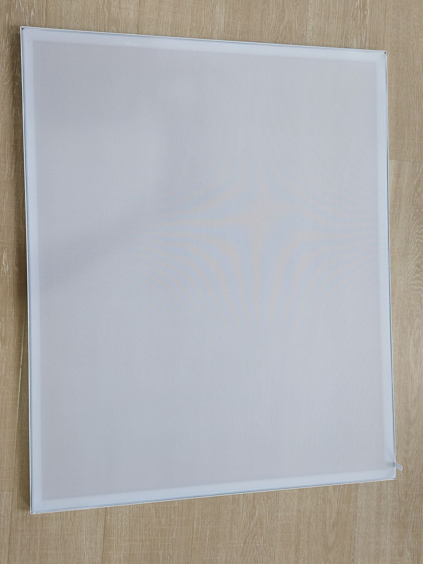 80gsm sheer fabric panel on the workbench, bench texture readable through the tensioned fabric