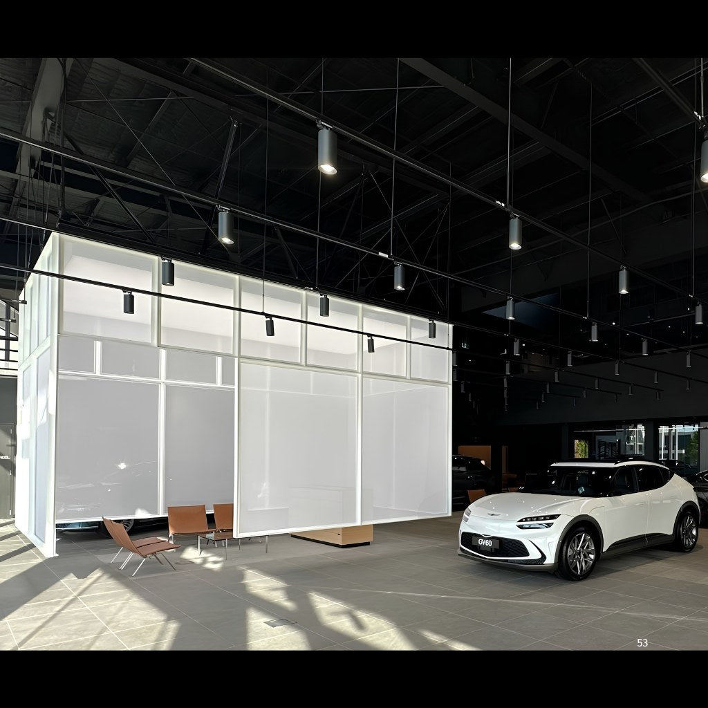Illuminated translucent fabric cube glowing in a premium car showroom, built with Di Emme Creative Solutions