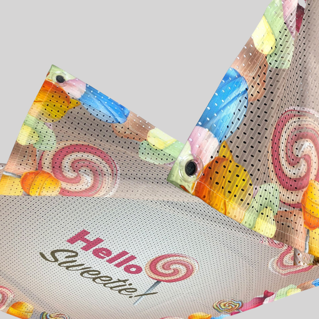 Printed fabric mesh banner with eyelets showing the perforated mesh